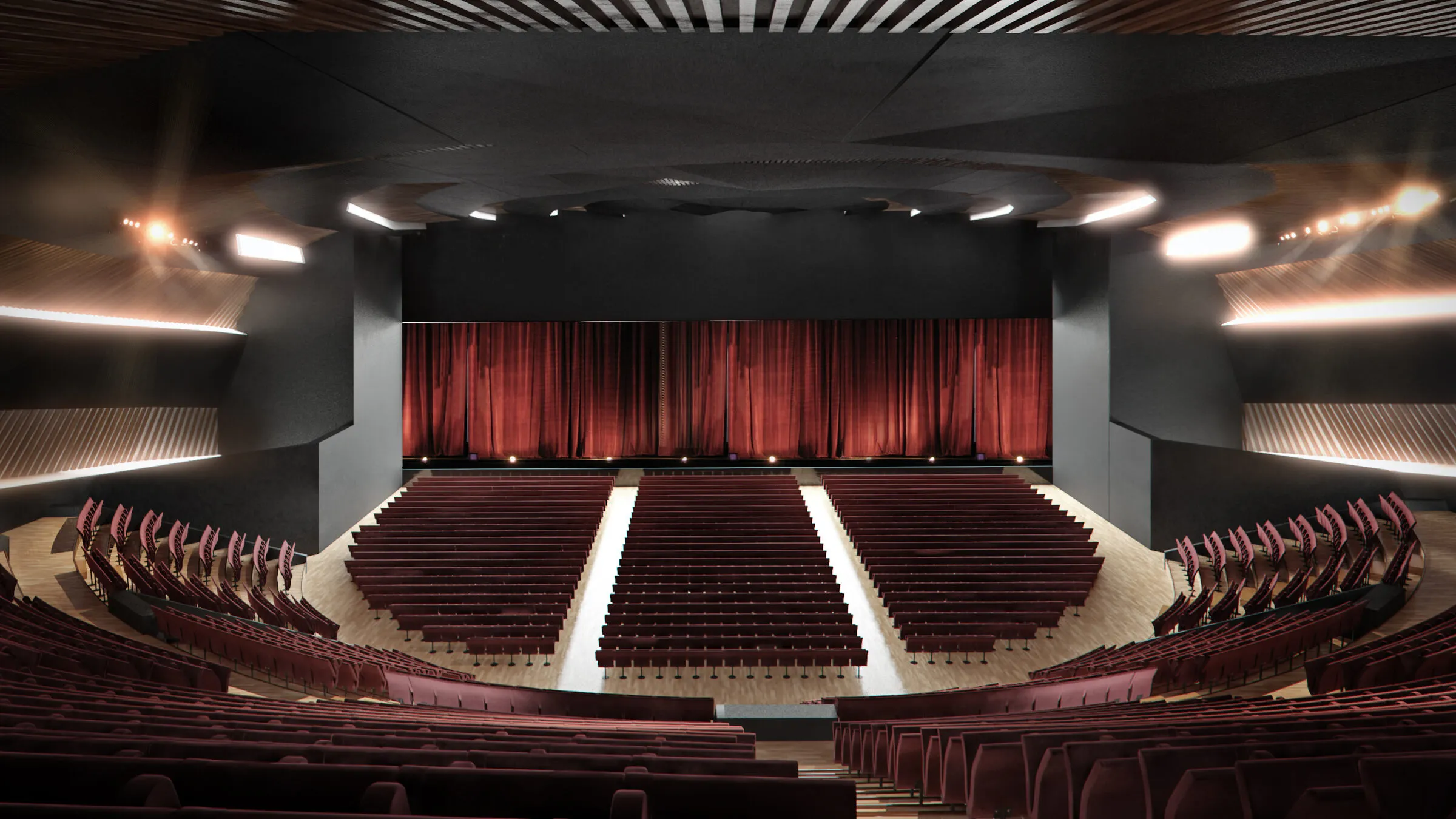 Поглед кон сцената со црвена завеса и седишта